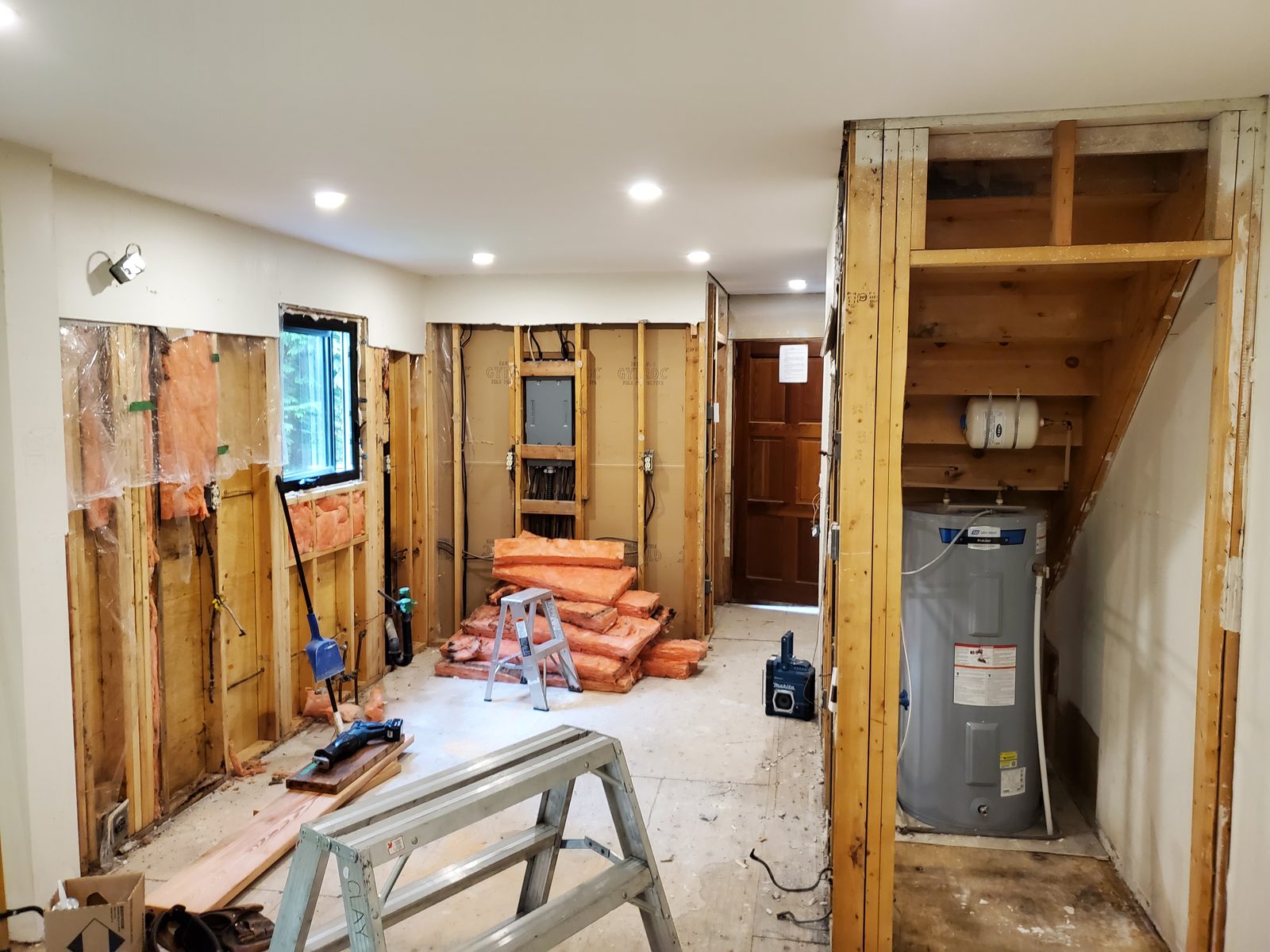 Interior renovation in progress, walls opened to the framing